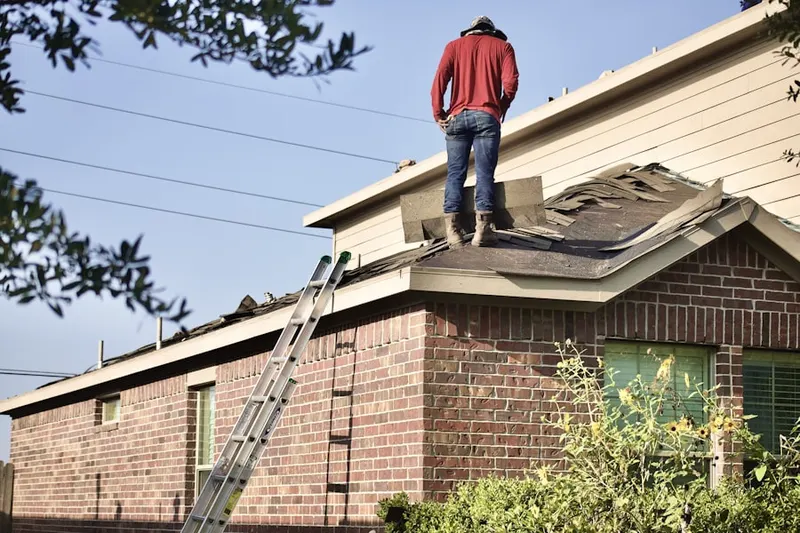 Professional roofer working on a residential roof in Felton Manor